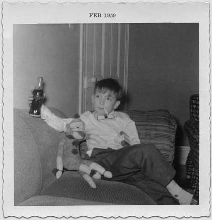 Me at seven, on the couch with my sock monkey.